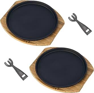 Set of two round sizzling steak plates with wooden tray