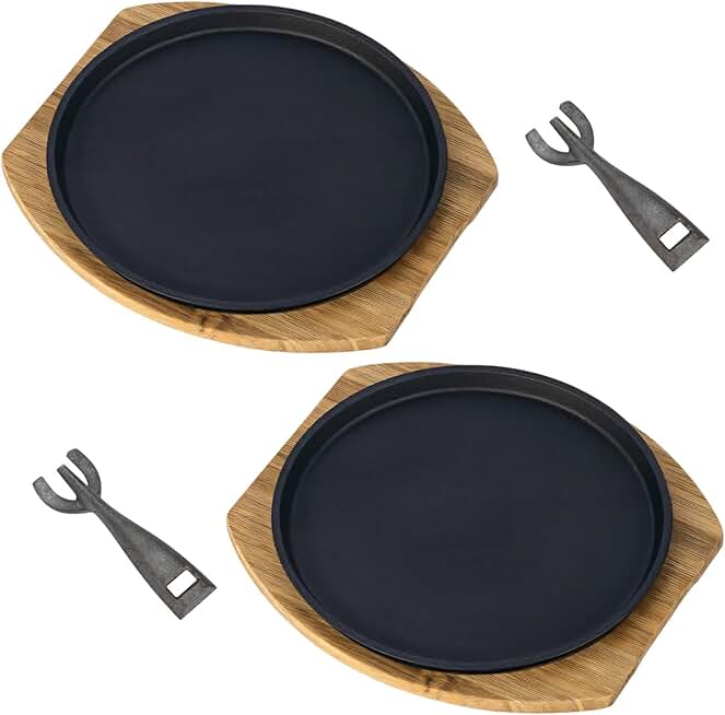 Set of two round sizzling steak plates with wooden tray