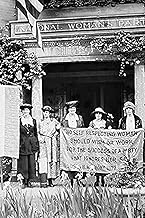 Suffragettes protest with banner in front of building