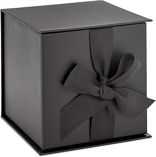 Small black gift box with bow and shredded paper fill
